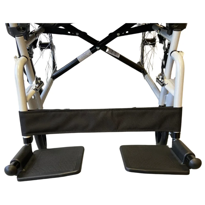 Close-up view of wheelchair footrests and frame.