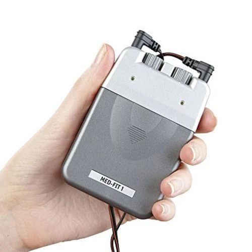 Person holding a handheld TENS machine with dials and wires.