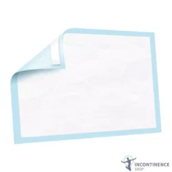 Disposable bed pad with blue border and corner folded.
