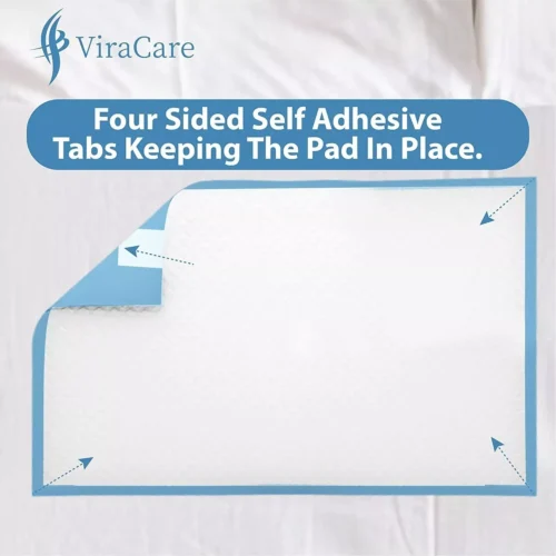 Disposable bed pad with four-sided adhesive tabs on a bed.