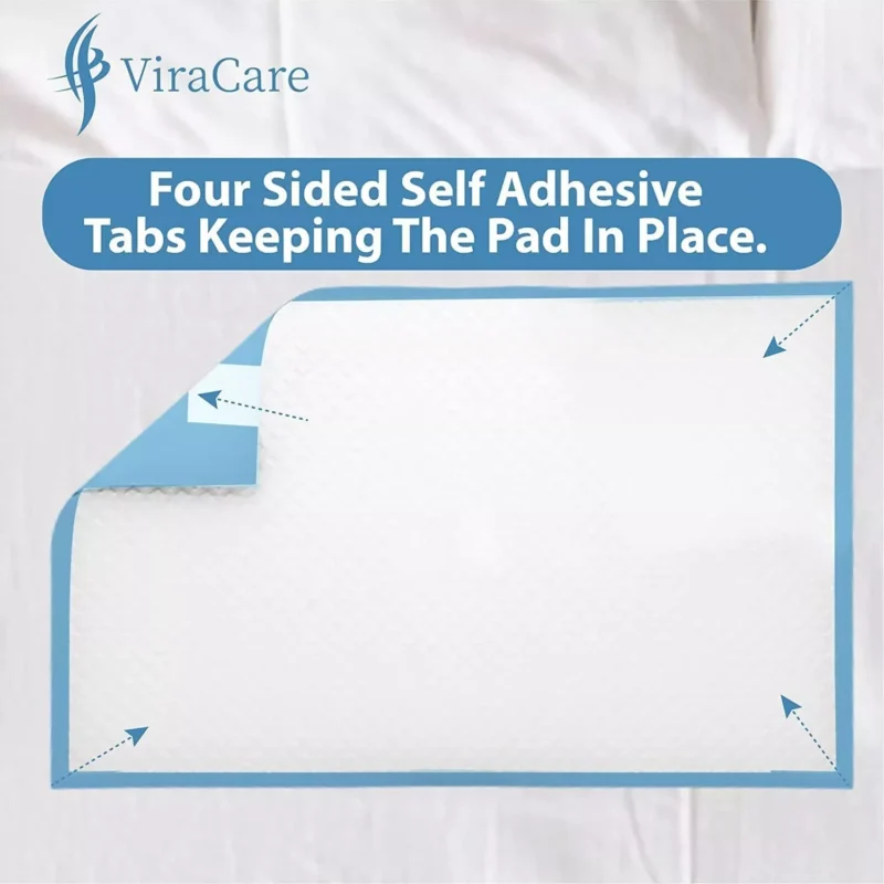 Disposable bed pad with four-sided adhesive tabs on a bed.
