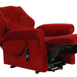 Red recliner chair with extended footrest and remote control.