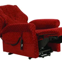 Red recliner chair with extended footrest and remote control.