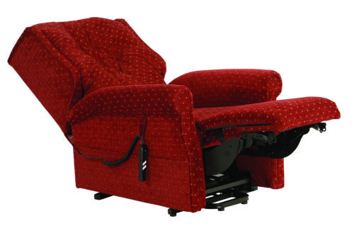 Red recliner chair with extended footrest and remote control.