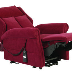 Red recliner chair with footrest extended and remote control attached.
