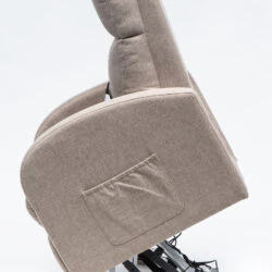 Side view of a beige rise and recline chair in a lifted position.