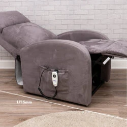 Reclined electric recliner chair with remote in side pocket.