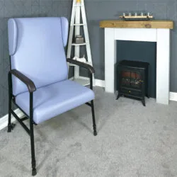 Light blue high back armchair with black frame in a cozy living room.