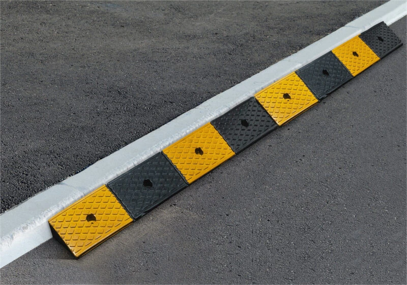 Rubber threshold ramp with alternating yellow and black sections.