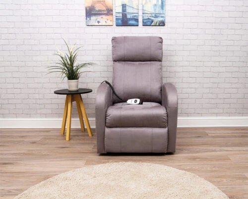 Modern electric recliner chair in a living room with a side table and plant.
