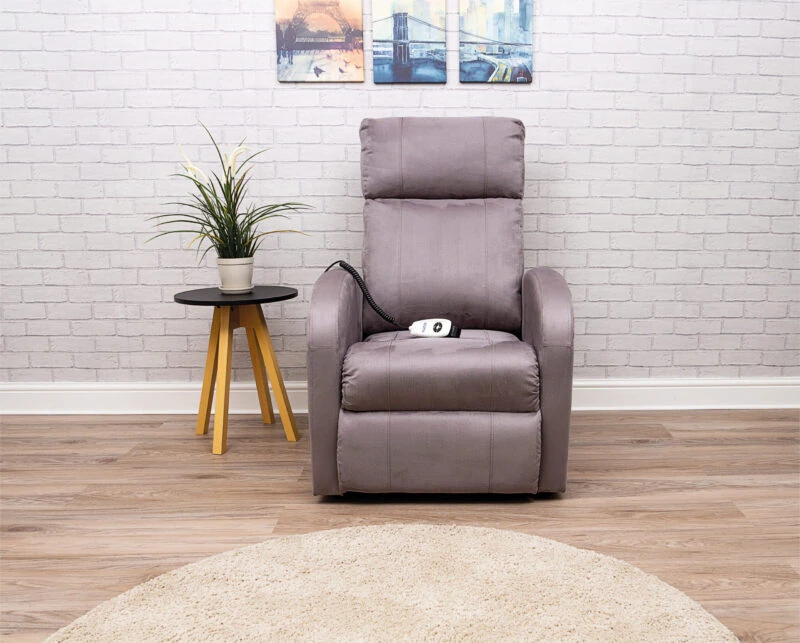 Modern electric recliner chair in a living room with a side table and plant.