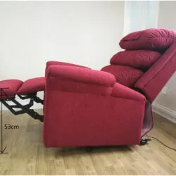 Red recliner armchair in a reclined position with footrest extended.