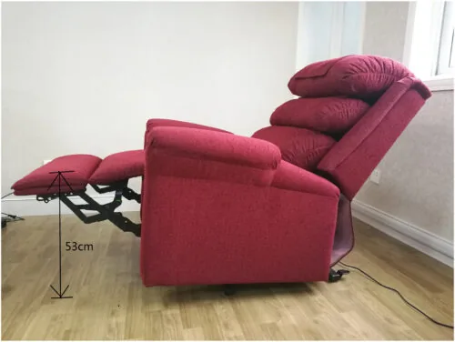 Red recliner armchair in a reclined position with footrest extended.