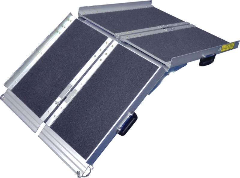 Trifold ramp with gritted surface and side rails for wheelchairs.