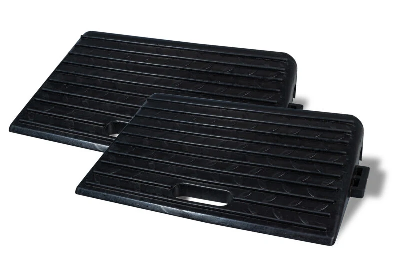 Two black rubber threshold ramps with textured surface and handle cutouts.