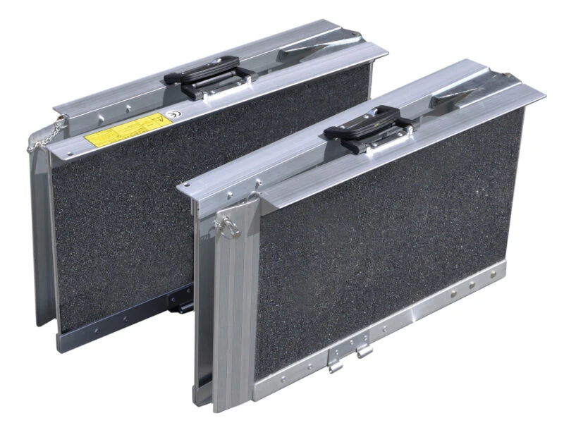 Two folded trifold ramps with gritted surfaces and handles.