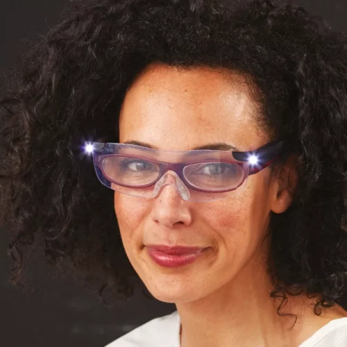 Person wearing LED magnifying glasses with lights on.