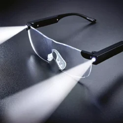 LED magnifying glasses with lights on a dark surface.