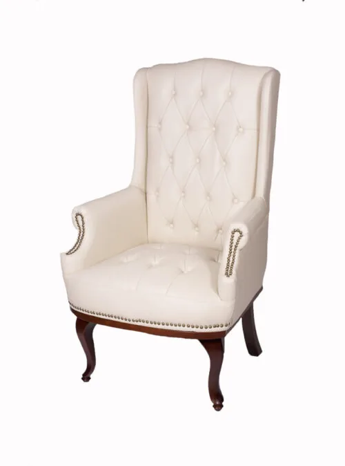 Cream high back armchair with dark mahogany legs and tufted upholstery.