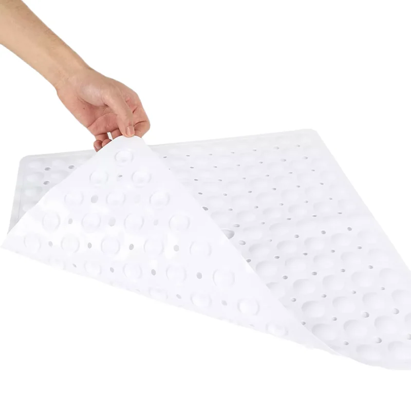 Hand lifting a white anti-slip shower mat with suction cups.