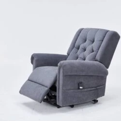 Grey recliner chair with buttoned back and extended footrest.
