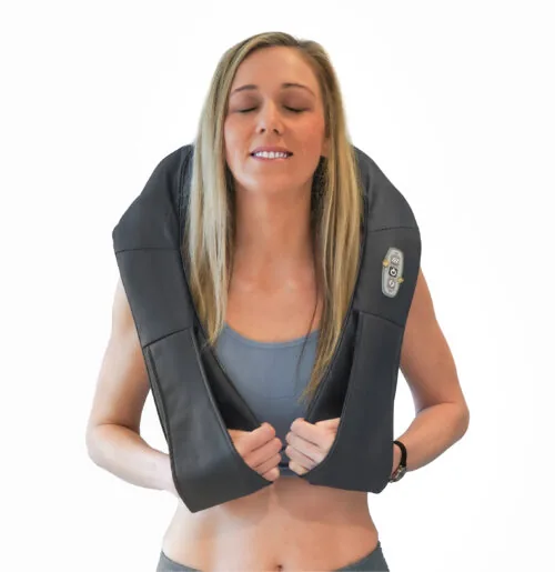 Woman wearing a neck and shoulder massager with control panel visible.