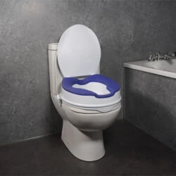 Elevated toilet seat with blue TPR padding and lid in a bathroom setting.