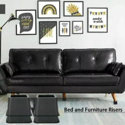 Black furniture raisers placed under a black sofa in a decorated living room.