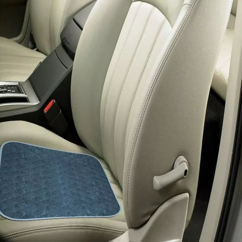 Blue incontinence chair pad placed on a car seat.