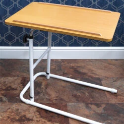 Overbed table with a beech melamine tabletop and white metal frame.
