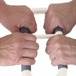 Two pairs of hands gripping the Stander Handy Handle.