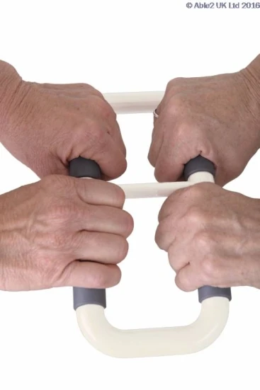 Two pairs of hands gripping the Stander Handy Handle.