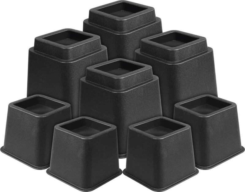 Eight black furniture raisers of varying heights stacked together.