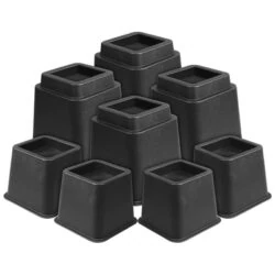 Eight black adjustable furniture raisers of varying heights.