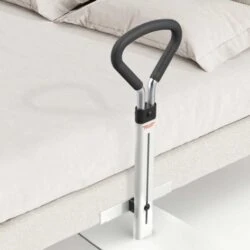 Bed support rail with a padded handle attached to a bed.