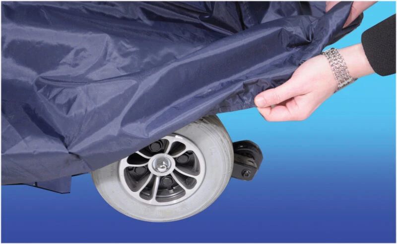 Navy blue cover being placed over a scooter wheel.