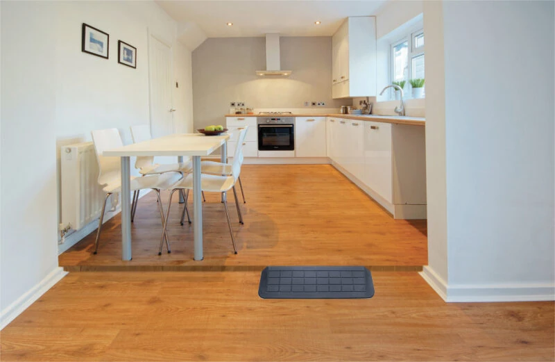 A threshold ramp placed in a kitchen doorway.