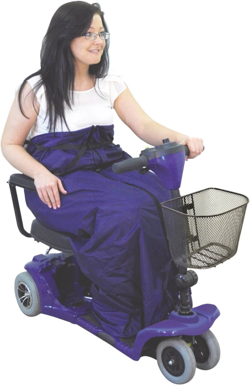 Woman using a mobility scooter with a purple fleece lined cosy.