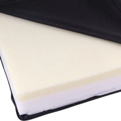 Close-up of a memory foam wheelchair cushion with a black vinyl cover partially opened.