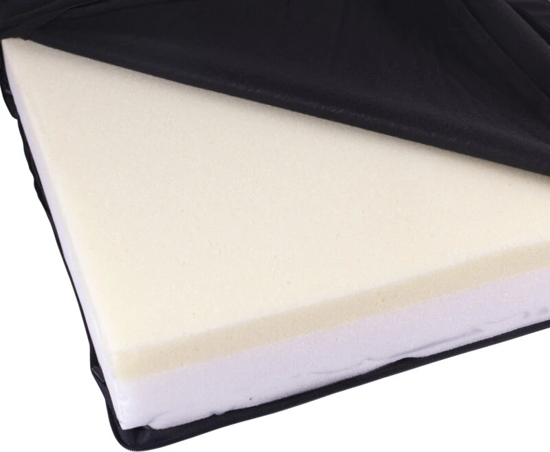 Close-up of a memory foam wheelchair cushion with a black vinyl cover partially opened.