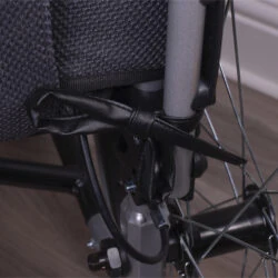 Close-up of a wheelchair cushion with black vinyl corner ties.
