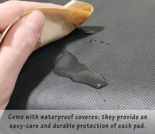 Hand wiping water off a black waterproof cushion cover.
