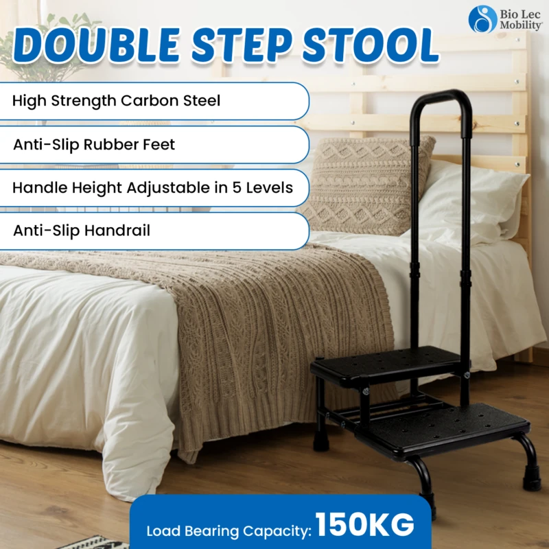 Double step stool with handle next to a bed, featuring anti-slip steps.