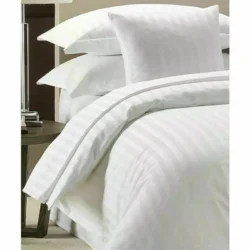White cotton duvet cover with matching pillowcases on a bed.
