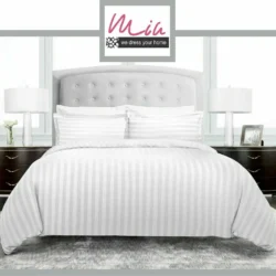 White striped duvet cover on a bed with pillows and bedside tables.