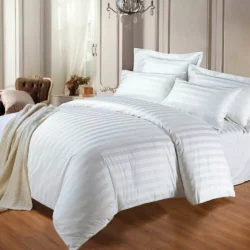 White striped cotton duvet cover set on a bed in a classic room.