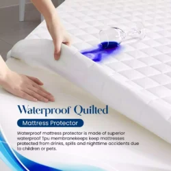 Person lifting a waterproof quilted mattress protector with spilled liquid on top.