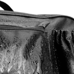 Close-up of a black waterproof bag with water droplets.