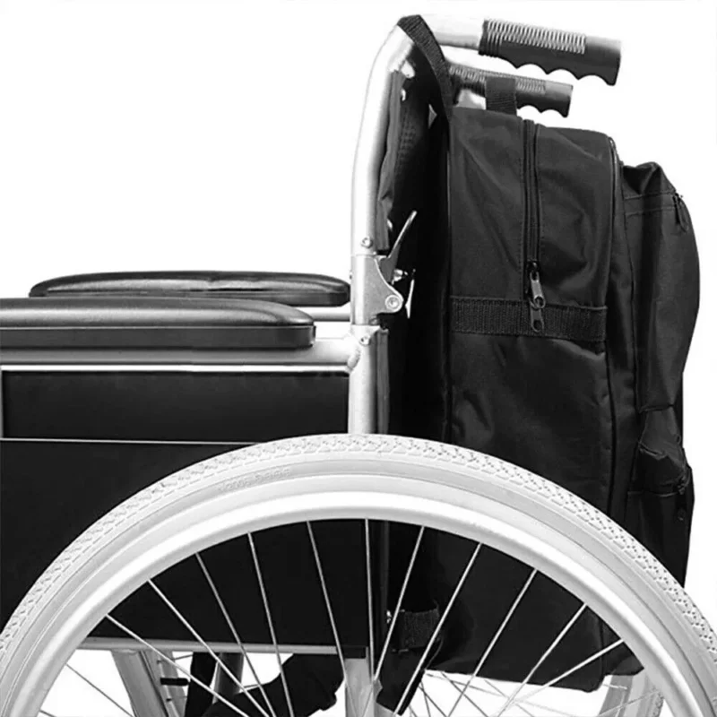 Black shopping bag attached to a wheelchair with visible zip compartments.