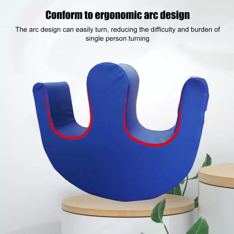 Blue U-shaped patient turning aid on a wooden surface.